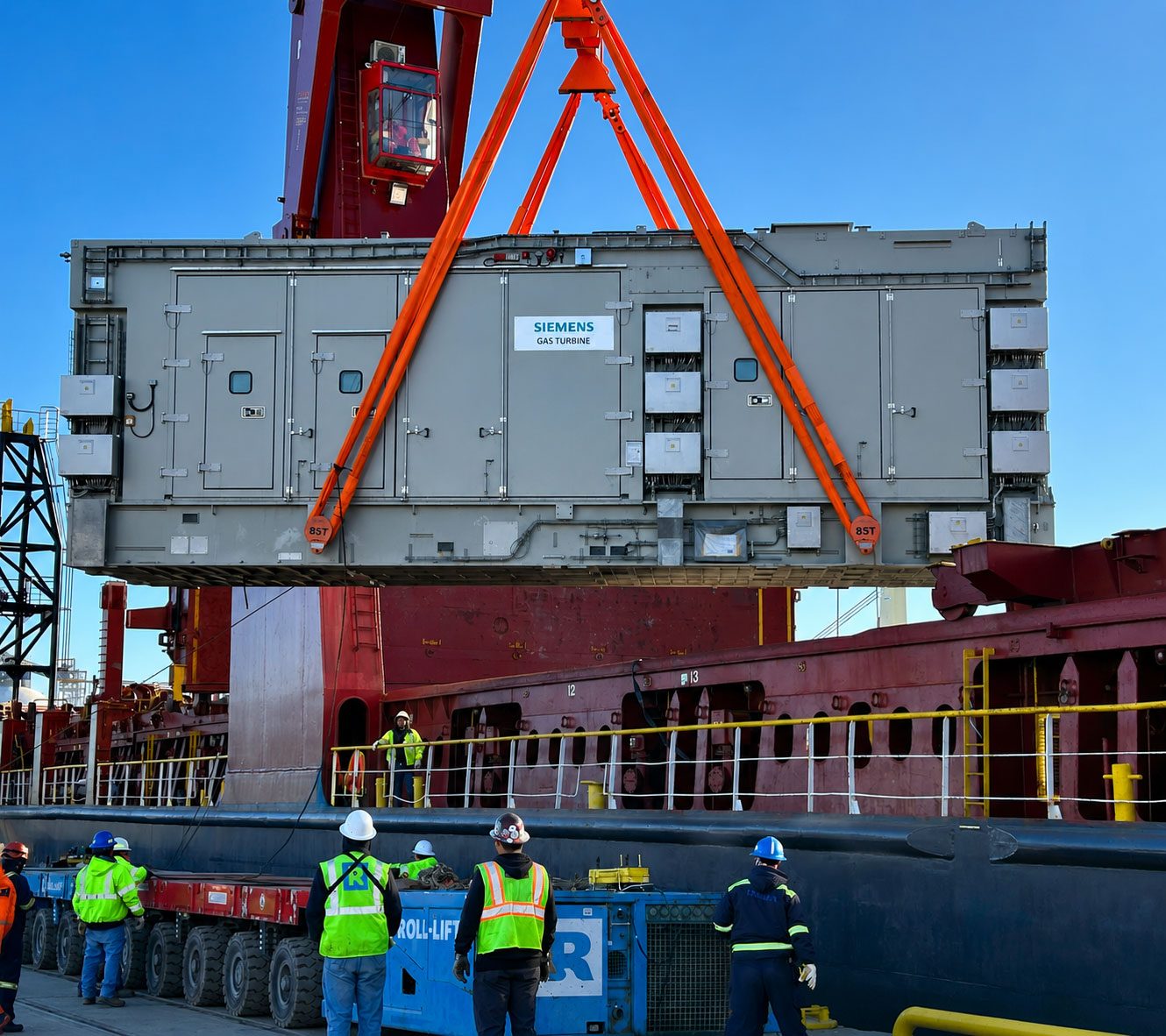 A Siemens Energy gas turbine module being lifted from a ship by a heavy-lift crane at the Port of Houston