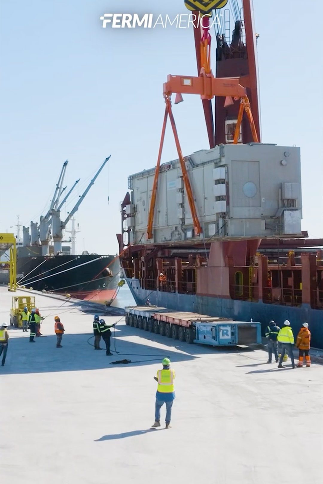 A Siemens Energy SGT-800 gas turbine package on a trailer at the dock with Fermi America crew in high-visibility vests